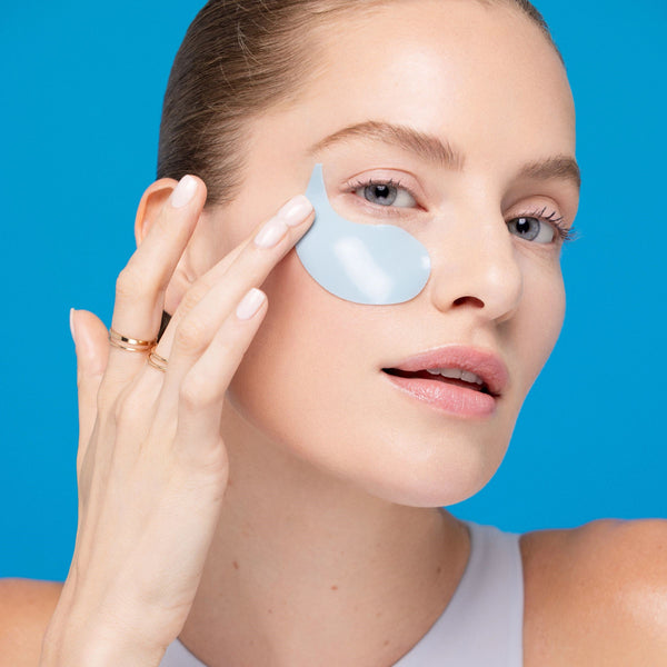 Person applying a Freeman Moisture Mask Face Set eye patch under their eye