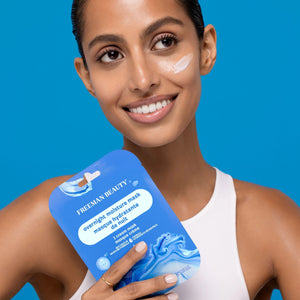 Person holding a Freeman Moisture Mask Face Set with cream applied to their cheek