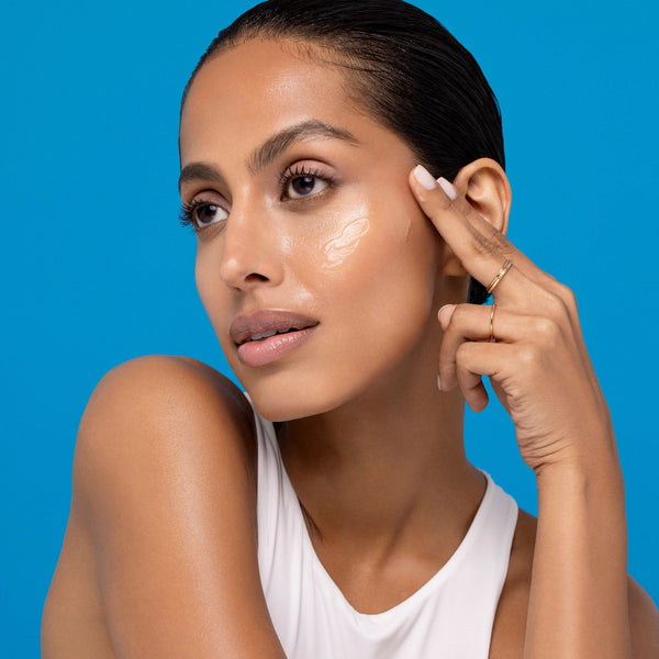 Person applying Freeman Moisture Mask Face Set to their cheek
