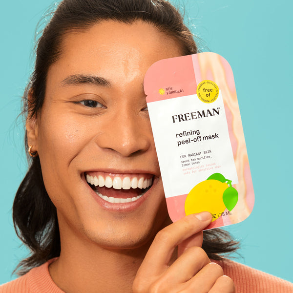 Person holding a FREEMAN refining peel-off mask packet in pink and white.