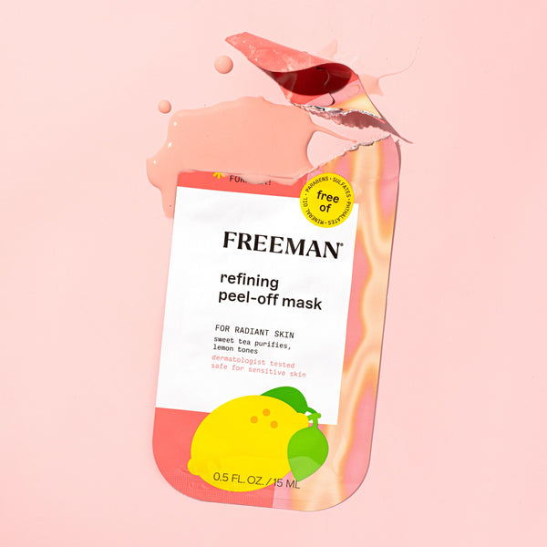 FREEMAN refining peel-off mask packet with lemon graphic, shown with liquid smear effect.