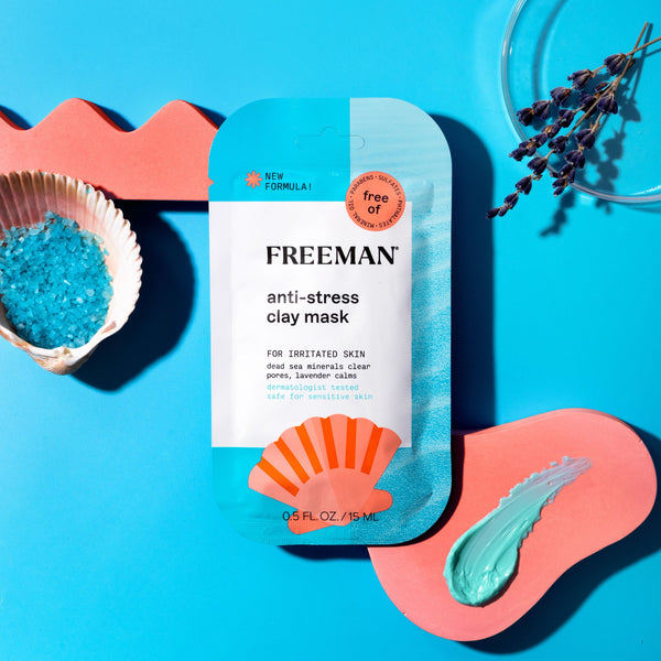 FREEMAN anti-stress clay mask packet on tabletop with turquoise and coral items.