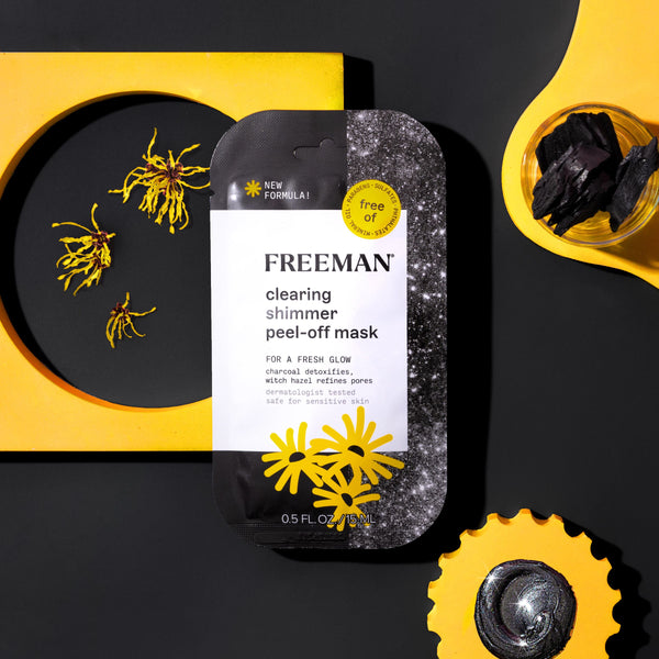FREEMAN clearing shimmer peel-off mask packet with yellow flower accents on dark background.