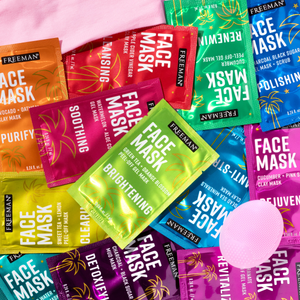 Colorful Freeman face mask packets with a round pink applicator pad in the foreground