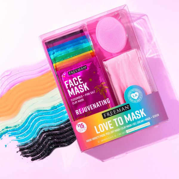 Open face mask kit with rainbow mini mask packets and a round pink applicator pad