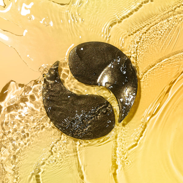 Black de-puffing hydrogel under-eye patch submerged in gel