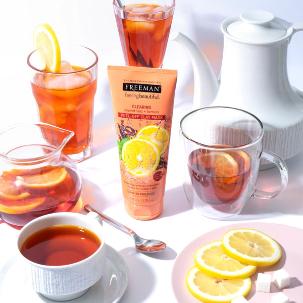 Freeman peel-off clay mask with tea cups and lemon slices on tabletop