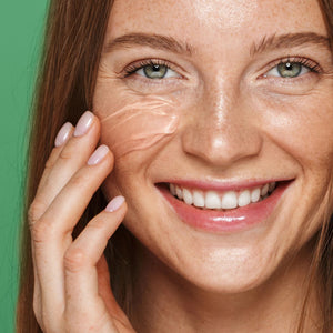 Hydrating face gel mask on smiling model, hand touching cheek