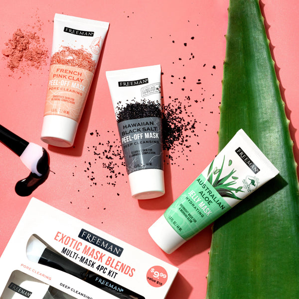 Exotic face mask kit flat lay with four mask tubes and brush