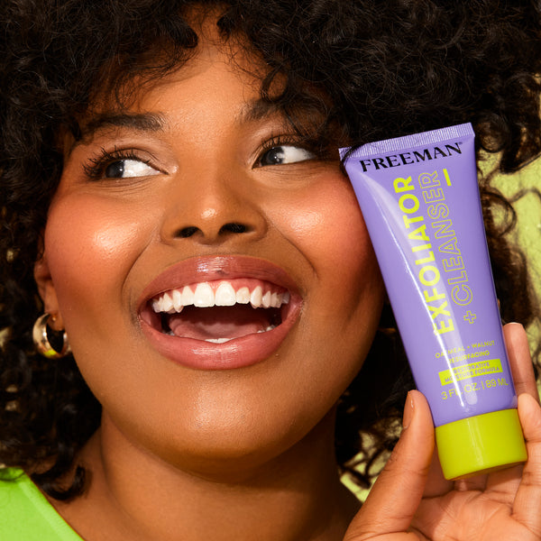 Woman holding a purple facial exfoliator cleanser tube with lime green cap