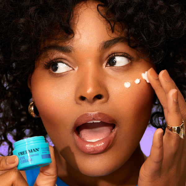 Eye cream application with small dots under the eye on a woman’s face