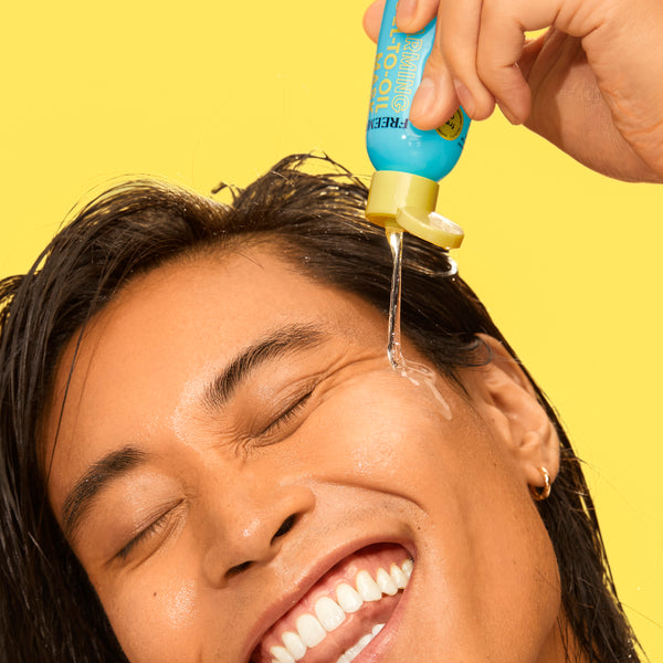 Restorative warming gel-to-oil facial mask gel being squeezed onto forehead