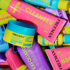 Assorted FREEMAN skincare tubes and balms piled together, including Moisture + Skin Shield