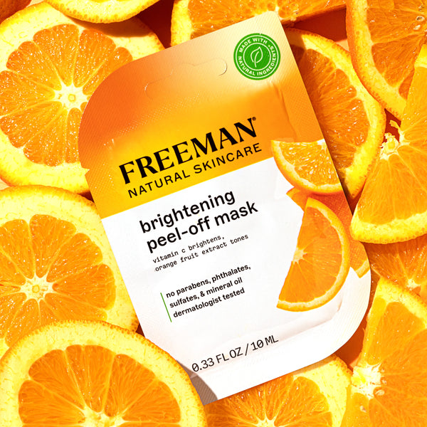 Freeman brightening peel-off mask pouch centered among orange slices